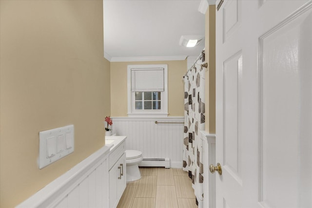 bathroom with vanity, toilet, ornamental molding, and baseboard heating