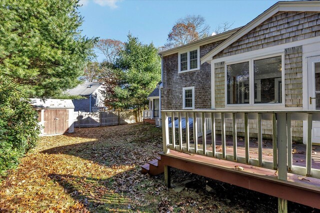 view of yard with a shed and a wooden deck