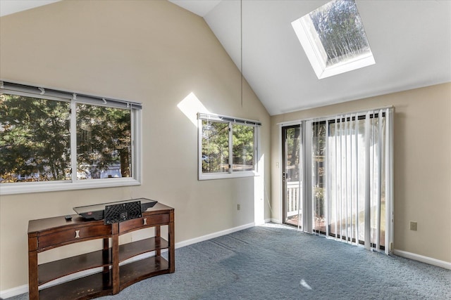 sitting room with carpet floors and vaulted ceiling with skylight