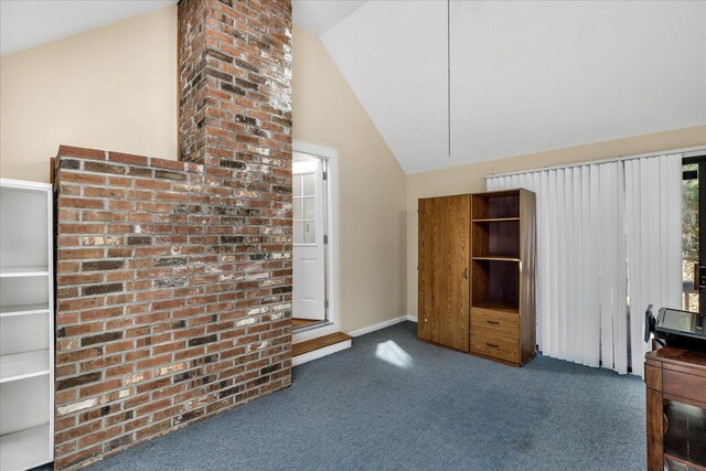 interior space with lofted ceiling and dark colored carpet