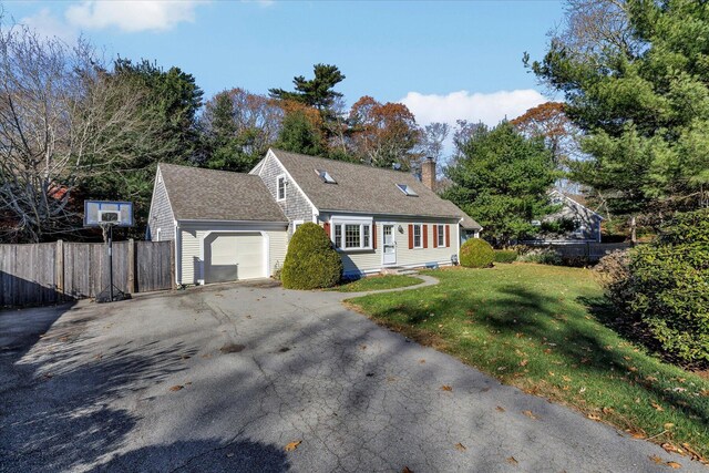 cape cod home with a garage and a front yard