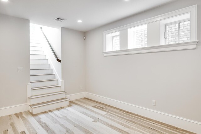 basement with light hardwood / wood-style floors