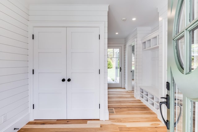bathroom with toilet, wallpapered walls, a wealth of natural light, and a wainscoted wall