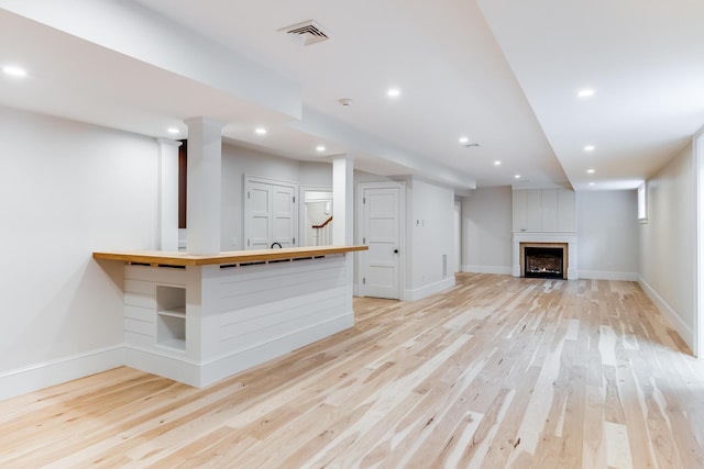 interior space with visible vents, baseboards, light wood-type flooring, and recessed lighting