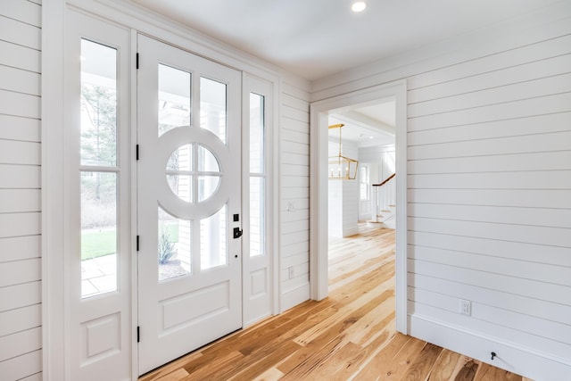 foyer with a decorative wall, visible vents, and a wainscoted wall