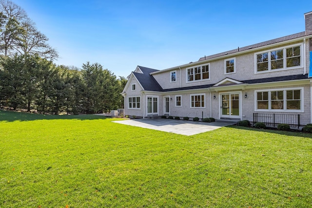 back of house featuring a yard and a patio