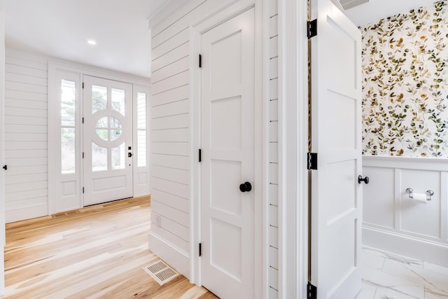 spare room featuring visible vents, baseboards, high vaulted ceiling, and wood finished floors