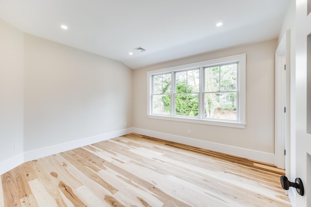 spare room with recessed lighting, baseboards, and wood finished floors