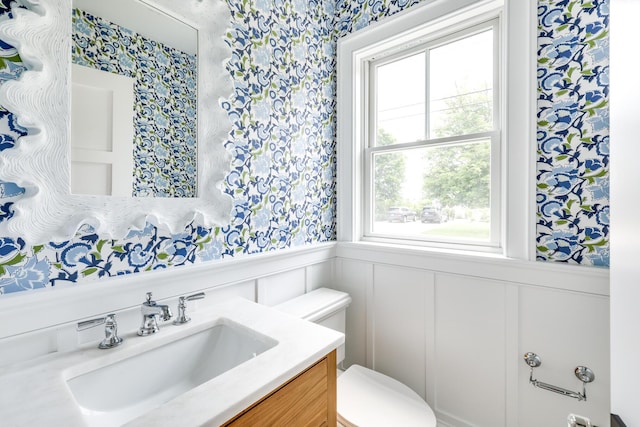 bathroom featuring toilet and vanity