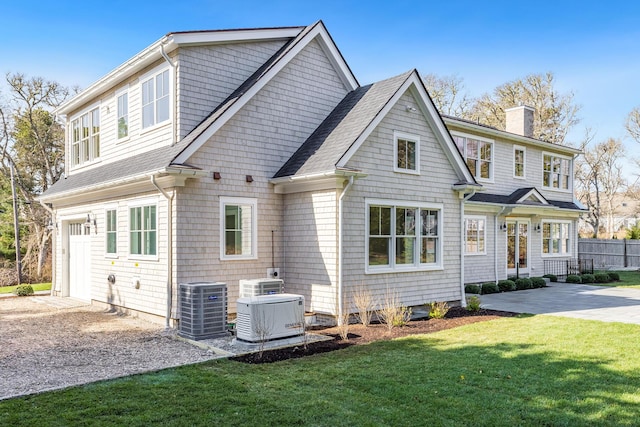 45 Meadow View Rd S, Chatham, MA 02633 - view of front facade with a chimney, driveway, and central AC