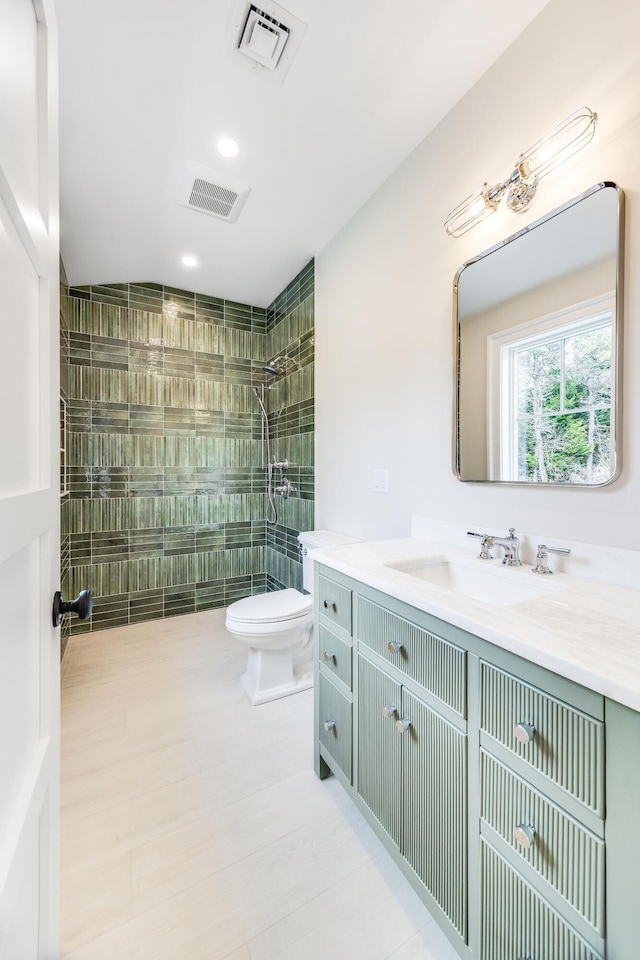 full bath with toilet, vanity, visible vents, and walk in shower