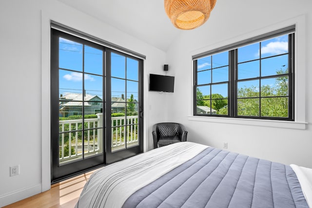 350 Bradford St Unit U5, Provincetown, MA 02657 - bedroom with vaulted ceiling, light wood finished floors, baseboards, and access to outside