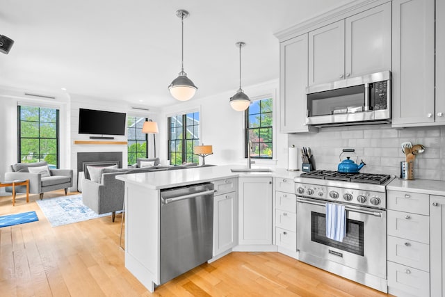 350 Bradford St Unit U5, Provincetown, MA 02657 - kitchen featuring stainless steel appliances, light wood-style flooring, a peninsula, light countertops, and recessed lighting