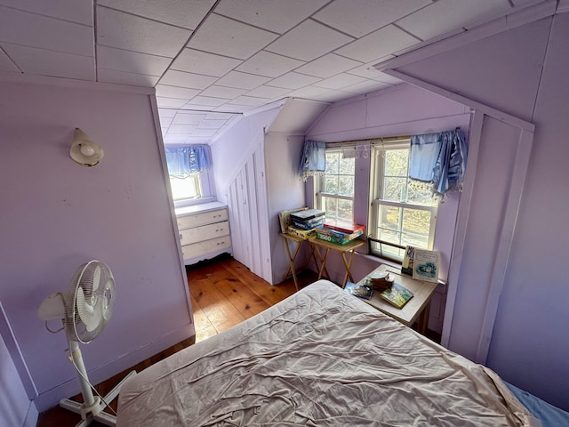 bedroom featuring light wood-style floors and lofted ceiling