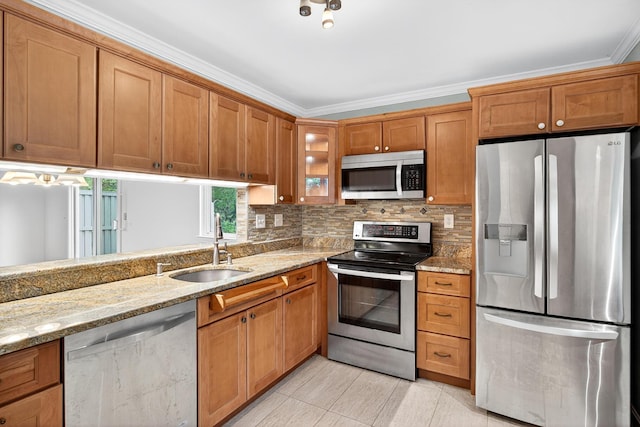 87 Susanna Dr, Brewster, MA 02631 - kitchen featuring appliances with stainless steel finishes, brown cabinetry, and crown molding