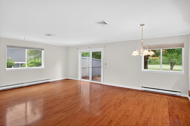 87 Susanna Dr, Brewster, MA 02631 - unfurnished room featuring a baseboard heating unit, plenty of natural light, a chandelier, wood finished floors, and ornamental molding