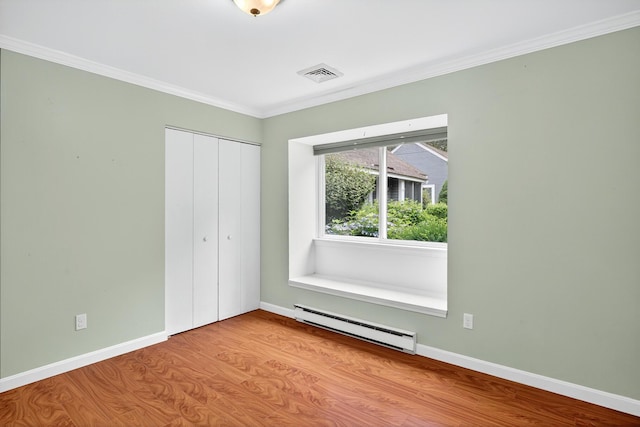 87 Susanna Dr, Brewster, MA 02631 - unfurnished bedroom with a baseboard heating unit, wood finished floors, a closet, and ornamental molding