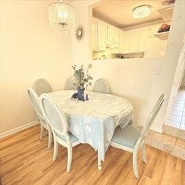 4 Westcliff Dr Unit 4, Cedarville, MA 02360 - dining area with light wood-style floors, baseboards, and a notable chandelier