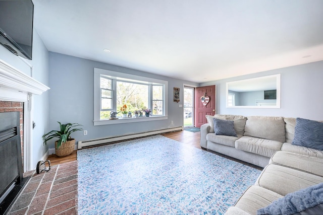 1 Stevens Way, Harwich, MA 02645 - living room featuring a baseboard heating unit, baseboards, a fireplace with flush hearth, and dark wood-type flooring