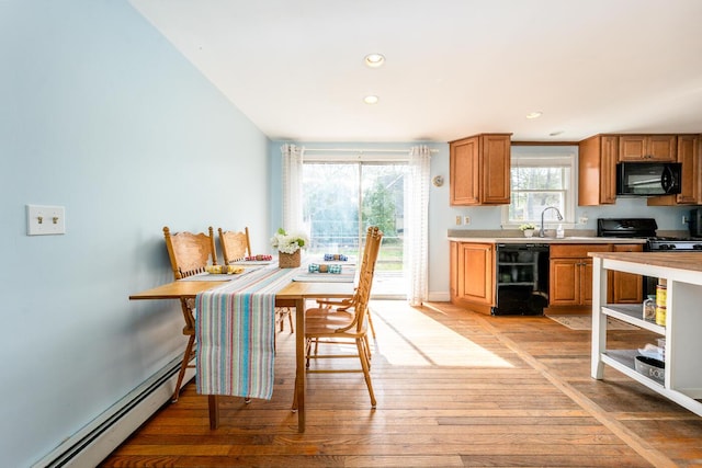 1 Stevens Way, Harwich, MA 02645 - kitchen with open shelves, light wood-style floors, light countertops, a baseboard heating unit, and black appliances