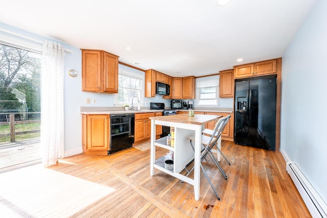1 Stevens Way, Harwich, MA 02645 - kitchen with black appliances, baseboard heating, a wealth of natural light, and light wood-style floors