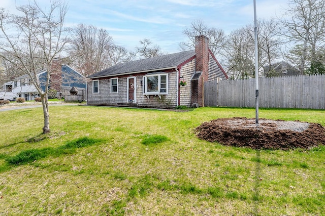 1 Stevens Way, Harwich, MA 02645 - view of front of home featuring a chimney, fence, a shingled roof, and a front lawn