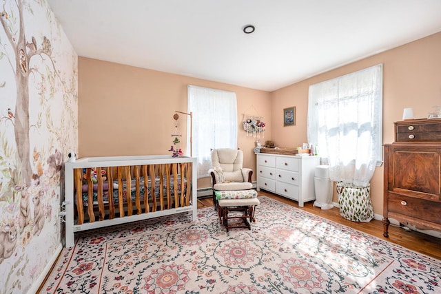 1 Stevens Way, Harwich, MA 02645 - living area with a wealth of natural light, wood finished floors, a baseboard heating unit, and baseboards