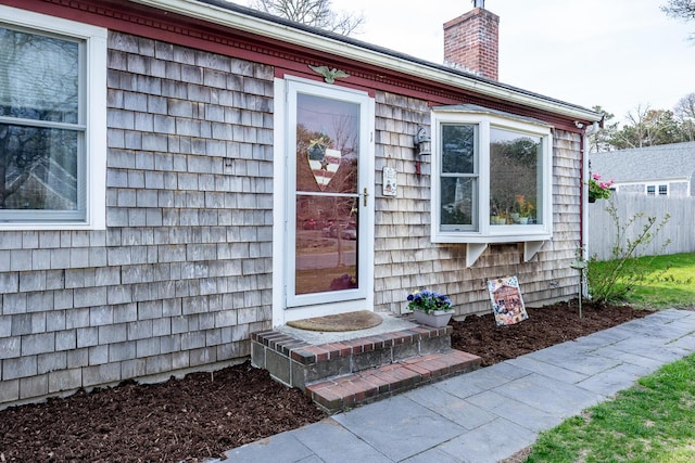 1 Stevens Way, Harwich, MA 02645 - view of exterior entry with a chimney and fence