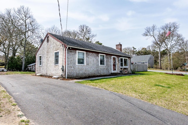 1 Stevens Way, Harwich, MA 02645 - ranch-style home with aphalt driveway, roof with shingles, a chimney, and a front yard