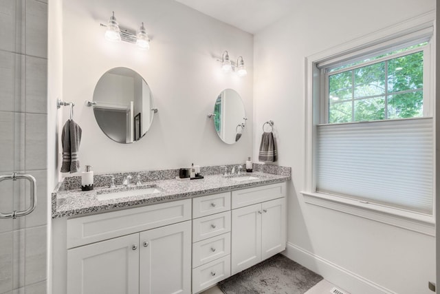 41 Old Main Rd Unit 3Au, North Falmouth, MA 02556 - bathroom featuring double vanity, a tile shower, and baseboards
