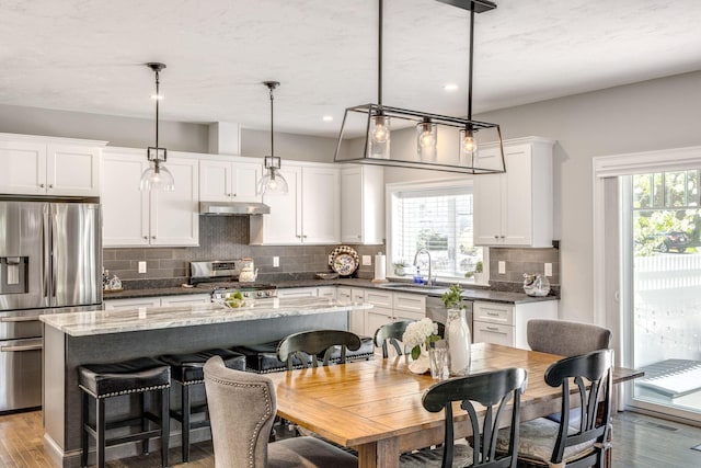 41 Old Main Rd Unit 3Au, North Falmouth, MA 02556 - kitchen featuring appliances with stainless steel finishes, a sink, under cabinet range hood, a kitchen island, and tasteful backsplash