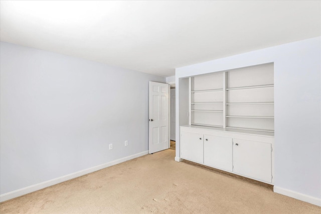 unfurnished bedroom featuring a closet and light carpet