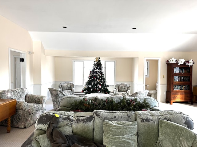 carpeted living room with vaulted ceiling