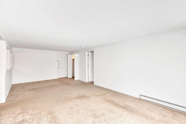 spare room with light colored carpet and a baseboard radiator