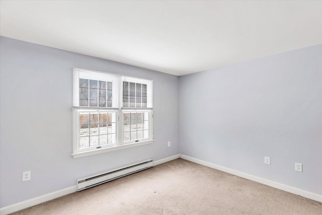 spare room featuring baseboard heating and carpet flooring