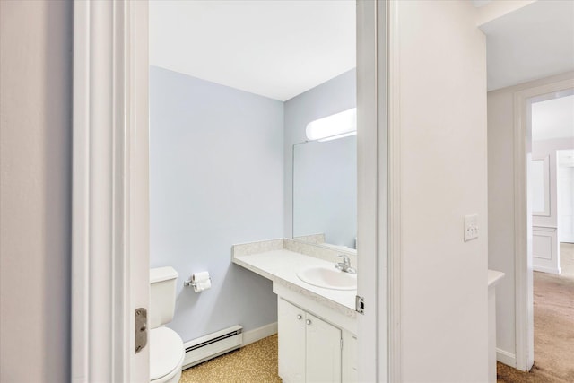 bathroom with toilet, a baseboard heating unit, and vanity