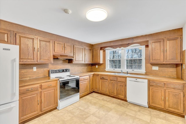 kitchen featuring sink and white appliances