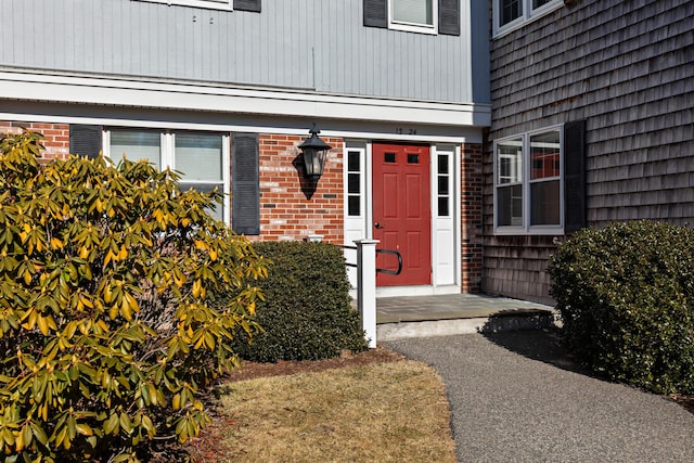 property entrance featuring brick siding