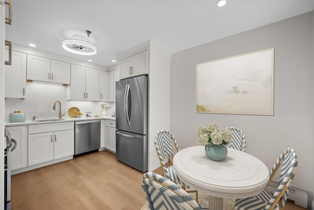 kitchen with light wood-style floors, recessed lighting, light countertops, white cabinets, and appliances with stainless steel finishes
