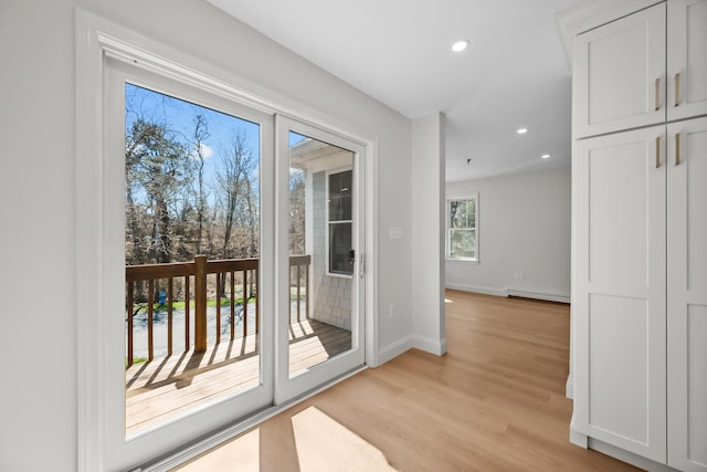 doorway to outside featuring recessed lighting, baseboards, a baseboard heating unit, and light wood-type flooring