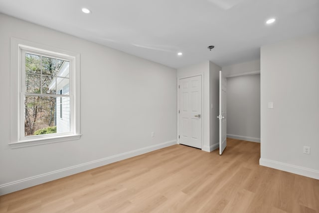 unfurnished bedroom featuring light wood-style floors, recessed lighting, and baseboards