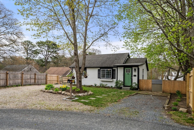 18 Race Rd, West Yarmouth, MA 02673 - view of front facade featuring roof with shingles and a fenced backyard