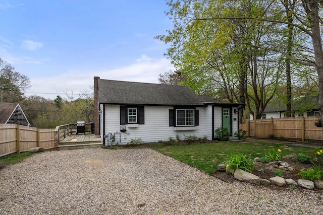 18 Race Rd, West Yarmouth, MA 02673 - view of front of property featuring fence, a wooden deck, and roof with shingles