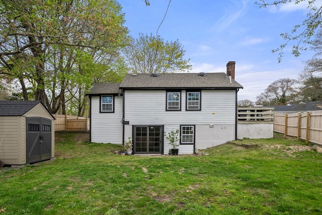 18 Race Rd, West Yarmouth, MA 02673 - back of property featuring a chimney, a storage unit, an outbuilding, and roof with shingles