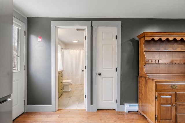 18 Race Rd, West Yarmouth, MA 02673 - bathroom with wood finished floors, toilet, baseboards, baseboard heating, and a shower with shower curtain