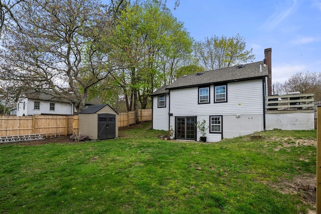 18 Race Rd, West Yarmouth, MA 02673 - back of property featuring a chimney, a storage shed, an outdoor structure, a deck, and roof with shingles