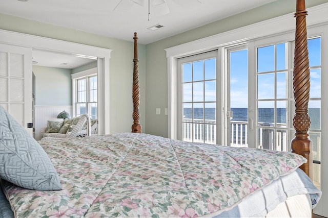 bedroom with a water view, ceiling fan, and access to outside