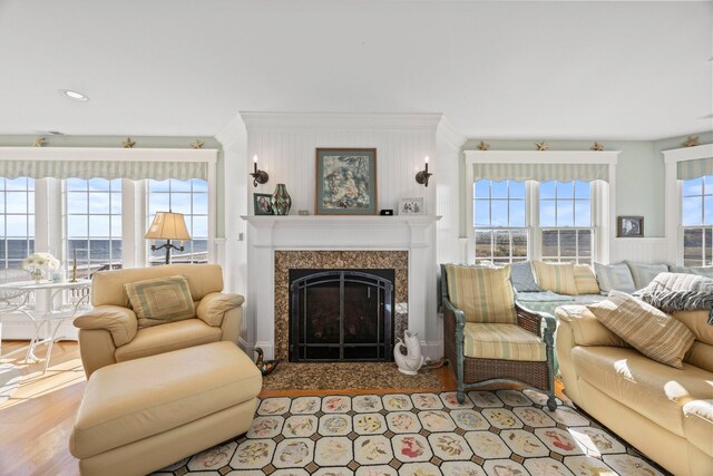 living room with light wood-type flooring and a high end fireplace