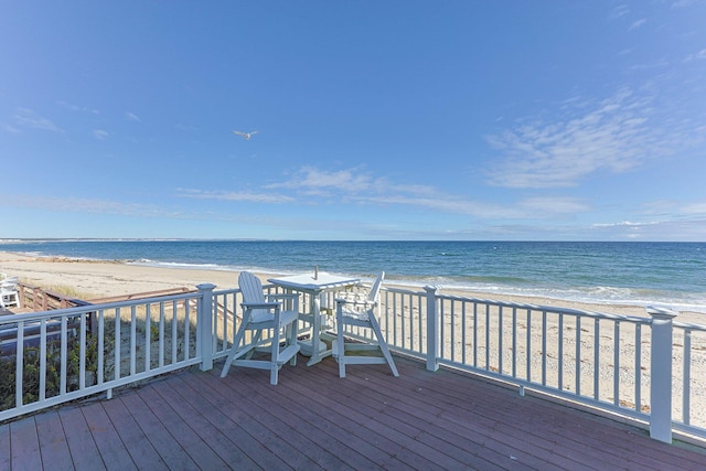 deck with a water view and a view of the beach