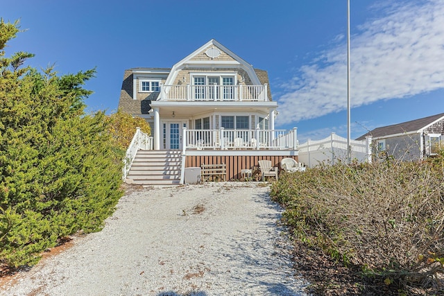 view of front of property featuring a balcony and covered porch